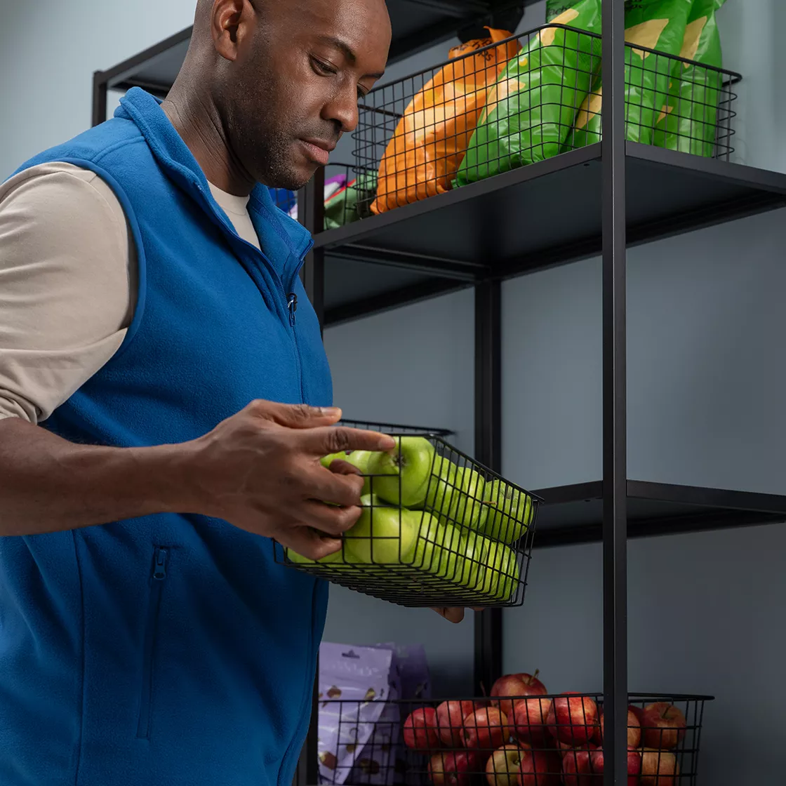 Man stacking shelfs in cafeteria